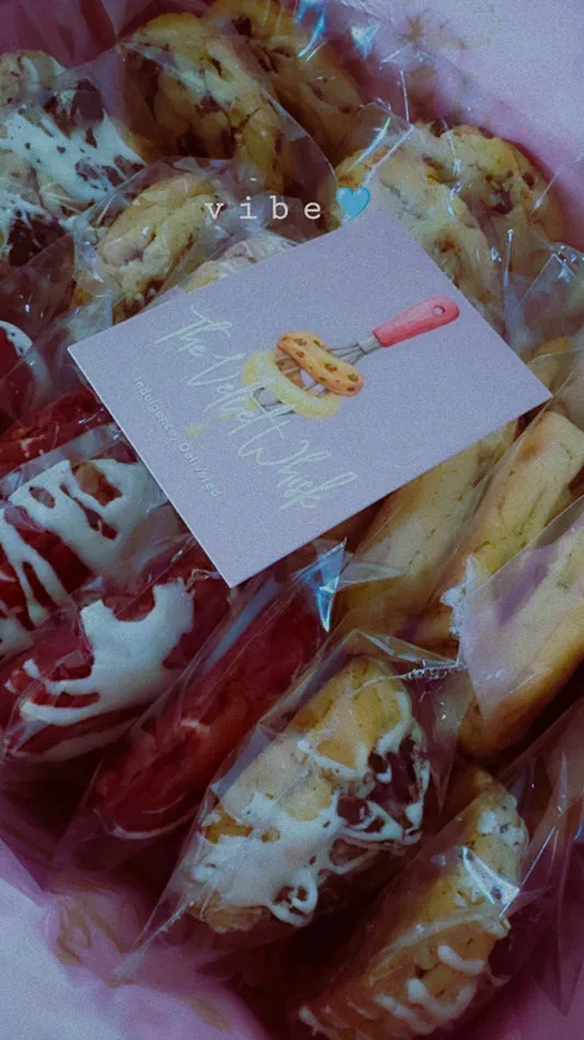 Assorted individually wrapped Velvet Whisk cookies in a gift box