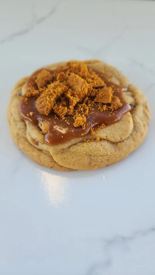 Chocolate chip cookie topped with cookie butter and cookie crumbs
