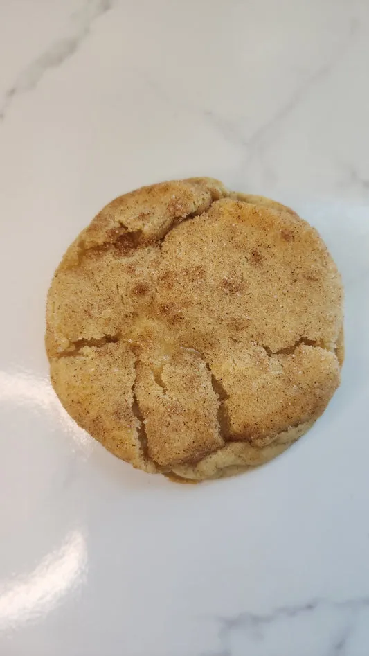 Cinnamon sugar snickerdoodle cookie on a marble surface